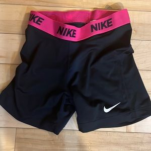 Pink and black Nike pros